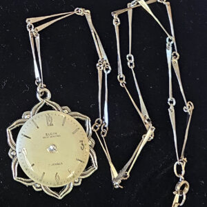 Necklace, silver tone 1 1/2" star shaped with round watch face, 24" chain with 1" links, spring ring clasp